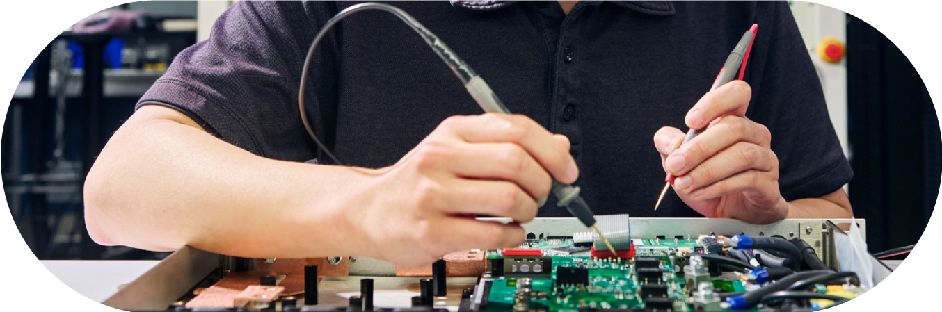 man working on circuit board TAE Technologies