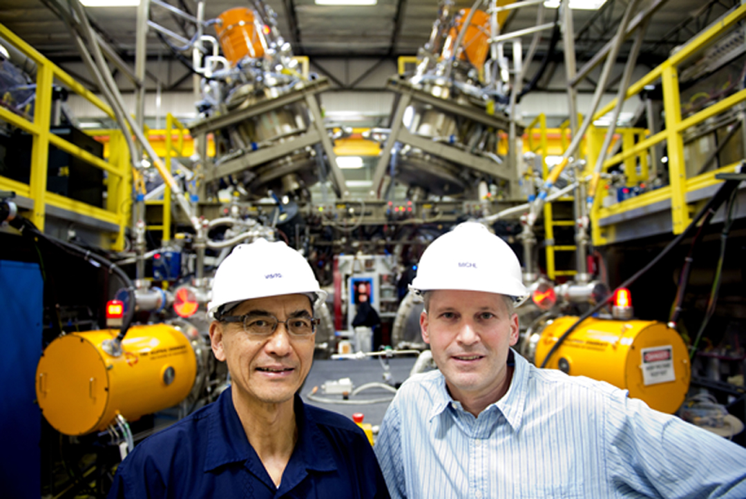 Michl Binderbauer, chief technology officer, left, and Toshiki Tajima, chief science officer, give a tour of Tri Alpha Energy.